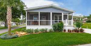 Silver Springs 5006 manufactured home with screened front porch and landscaped yard at Silver Bay