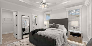 Bedroom inside the Silver Springs 5046 home model at Silver Bay in Palatka, Florida, featuring a spacious layout, bright windows, and modern finishes.