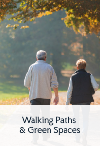 A senior couple taking a stroll on a walking path on a sunny day