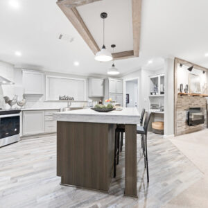 Image of an open floor plan white kitchen, complete with an island.