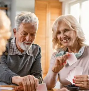 A couple of senior citizens playing cards